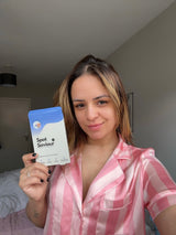 Woman in pink pyjamas holding Spot Saviour pimple patch box – real customer skincare testimonial