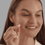 Standard acne patch applied with fingers by woman – higher risk of bacteria and contamination